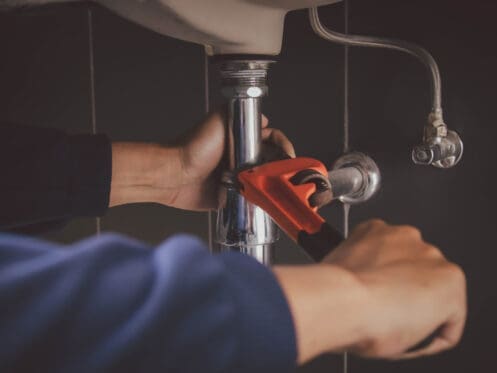Plumber Fixing Faucet